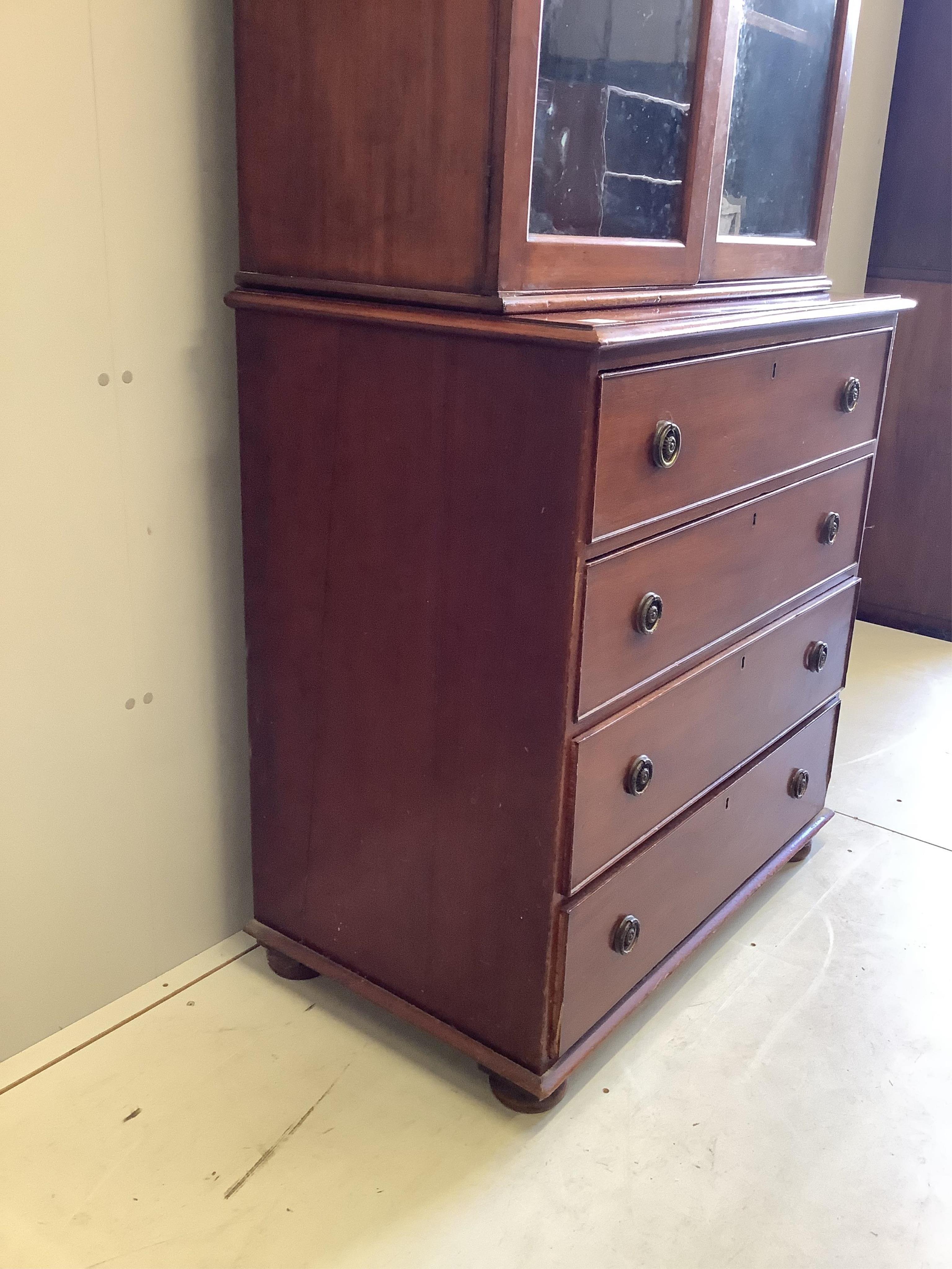 An Edwardian mahogany chest, fitted over with a two door glazed bookcase, width 96cm, depth 55cm, height 233cm. Condition - fair